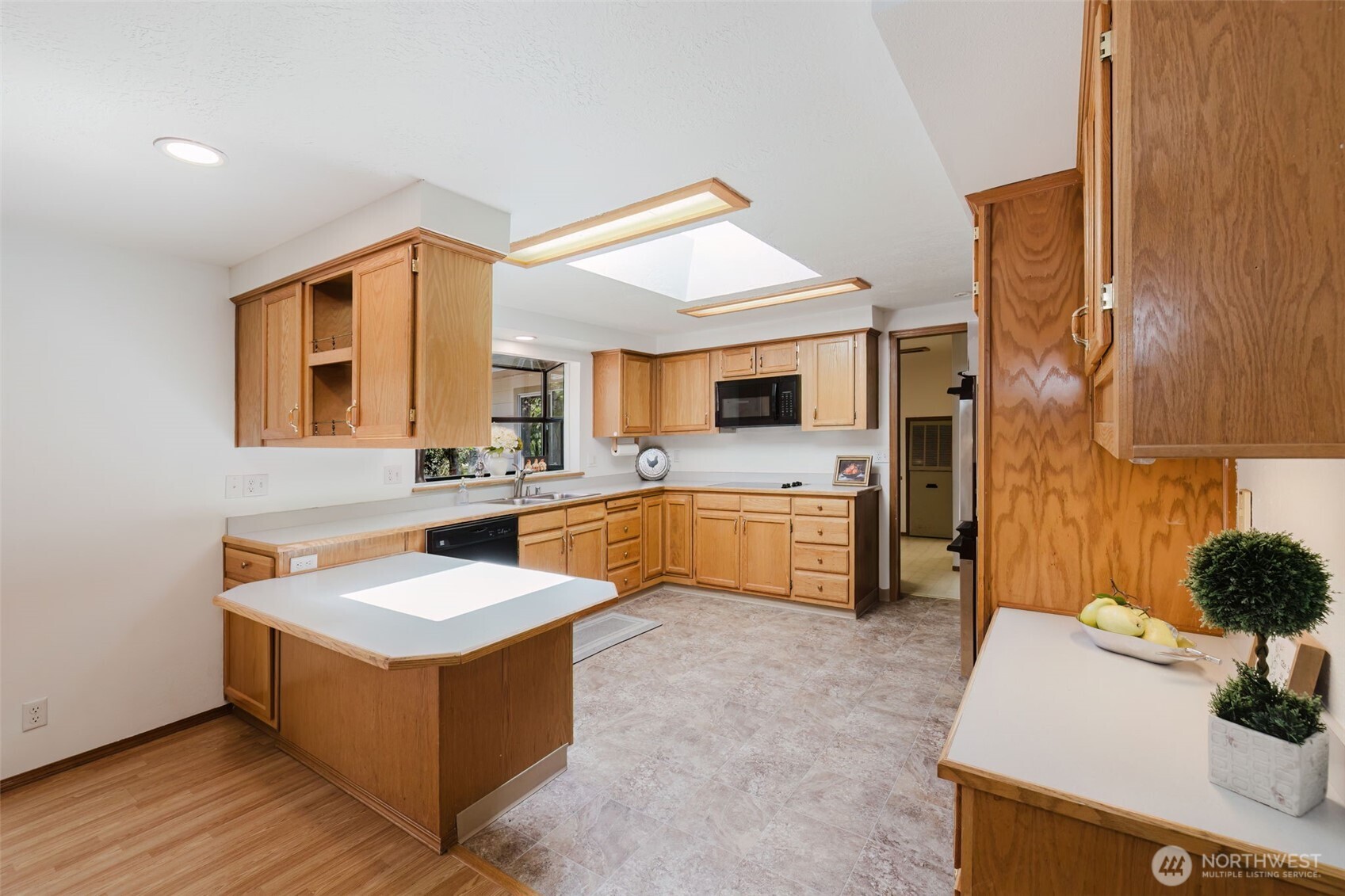 105 Schoolhouse Road Brinnon, WA 98320 - Photo 5 of 39 a large white kitchen with a sink and dishwasher a stove with wooden floor