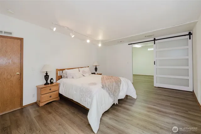 a bedroom with a bed and cabinet