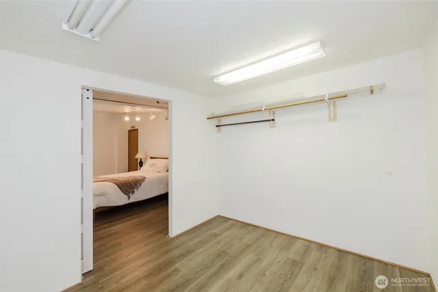 a view of a bedroom with wooden floor