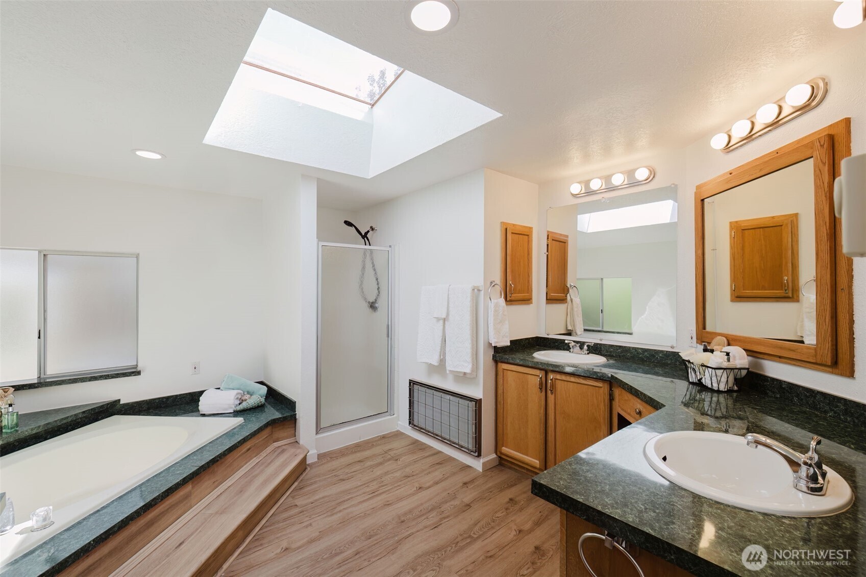 105 Schoolhouse Road Brinnon, WA 98320 - Photo 10 of 39 a bathroom with a granite countertop sink a mirror a vanity and shower