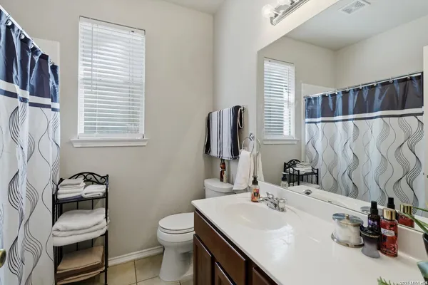 a bathroom with a sink a toilet and a mirror