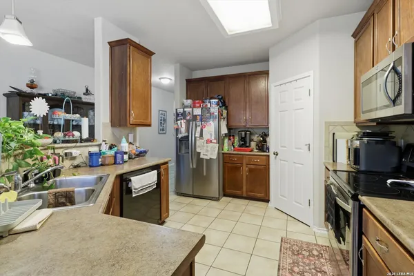 a kitchen with a refrigerator and a stove top oven