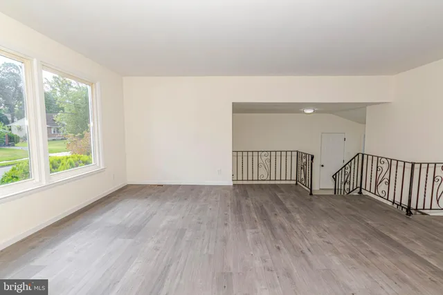a view of a kitchen with a sink dishwasher and wooden floor