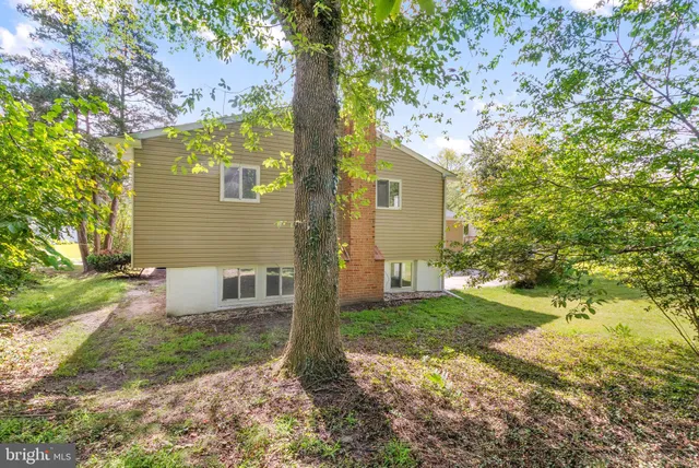 a view of a patio with table and chairs with wooden floor and fence