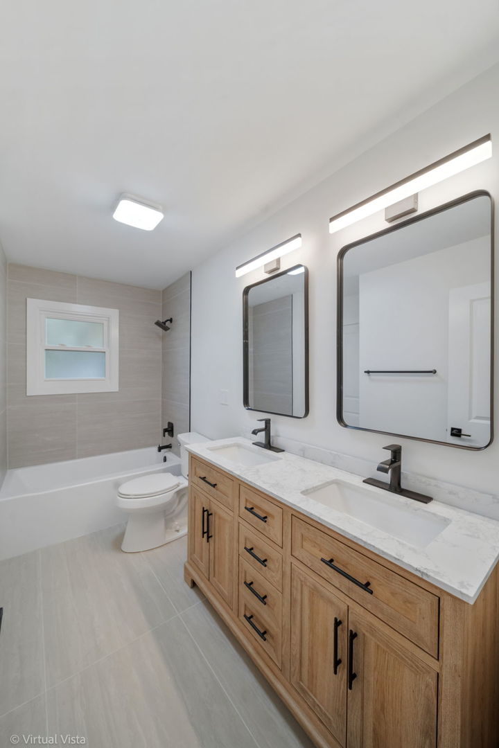 451 Alcester Court Bolingbrook, IL 60440 - Photo 14 of 22 a bathroom with a double vanity sink and mirror with bathtub
