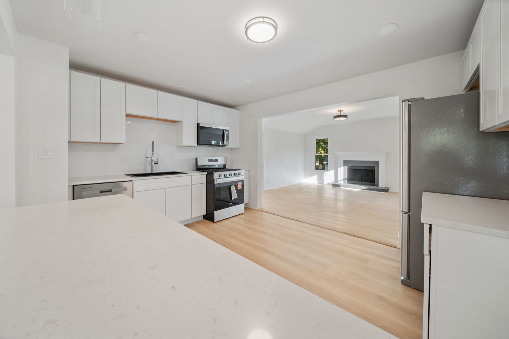 451 Alcester Court Bolingbrook, IL 60440 - Photo 8 of 22 a large white kitchen with stainless steel appliances granite countertop a stove and a refrigerator