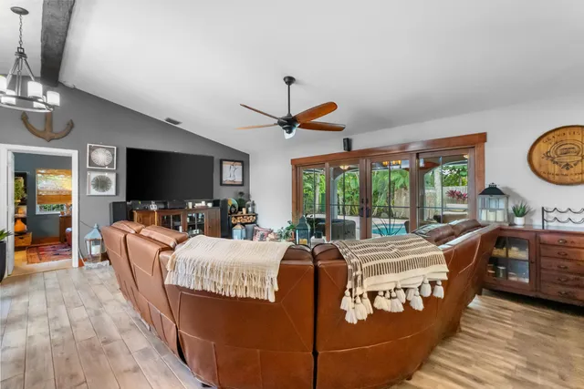 a kitchen with stainless steel appliances granite countertop a stove a sink dishwasher and a refrigerator with wooden cabinets