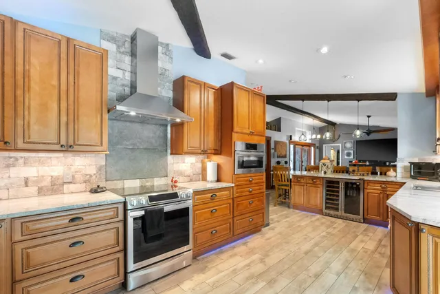 a large kitchen with a table and chairs