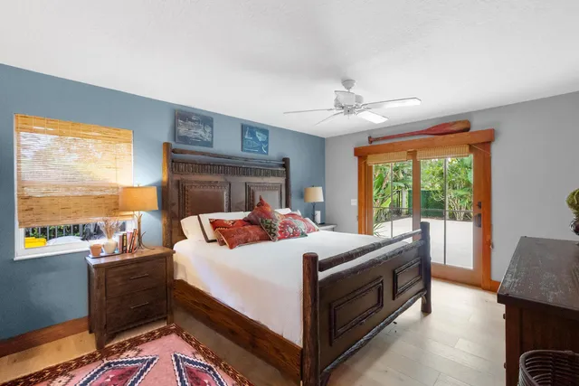 a bedroom with a bed and a flat tv screen on dresser