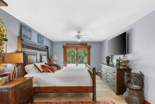 a bedroom with a bed and a flat screen tv