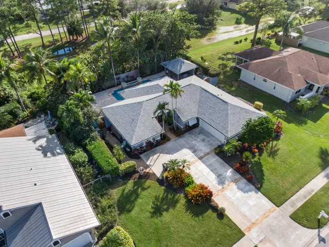 an aerial view of a house with a yard