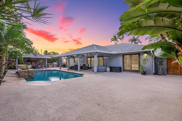 a view of house with swimming pool outdoor seating