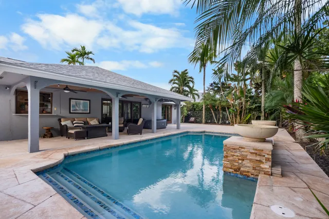 swimming pool view with a seating space