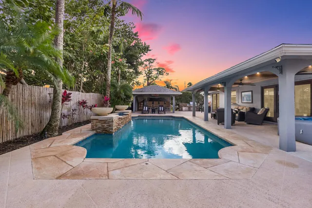 a backyard of a house with yard and outdoor seating