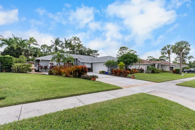 a front view of a house with a yard table and chairs