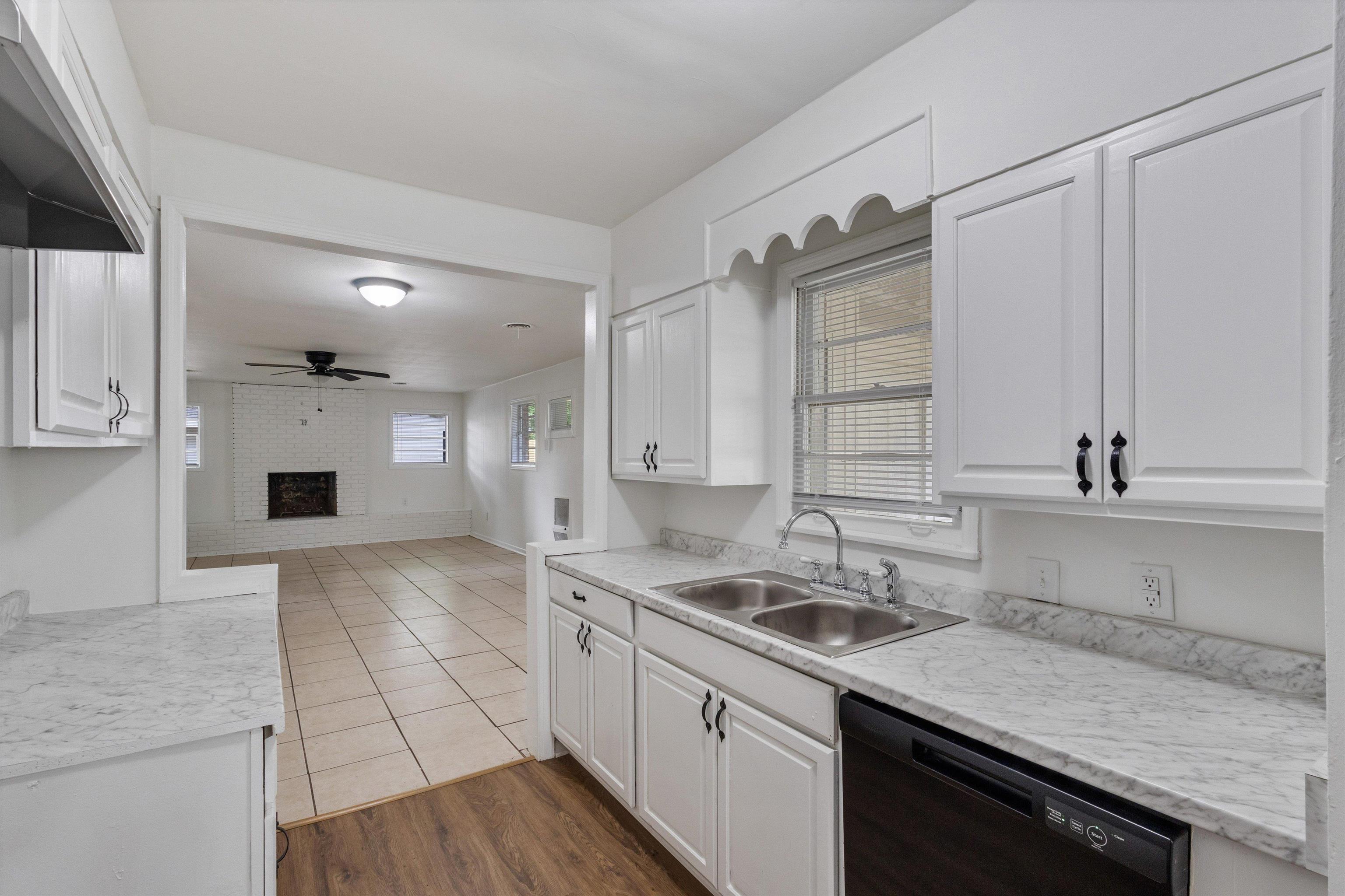 4565 Verne Road Memphis, TN 38117 - Photo 6 of 18 Kitchen featuring white cabinetry, stone-finish countertops, and a double-basin stainless steel sink