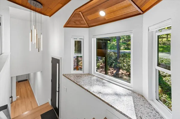 a bathroom with a granite countertop sink and a large mirror