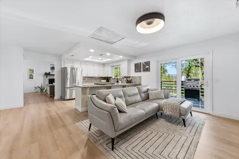 a living room with furniture and a wooden floor