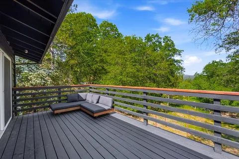 a view of a two chairs in the balcony