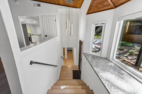 view of a hallway with wooden floor and staircase