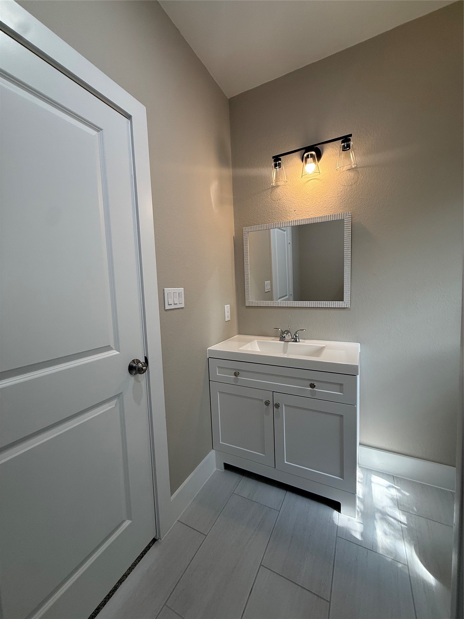 1816 Ryon Street Houston, TX 77009 - Photo 12 of 14 a bathroom with a sink and a mirror