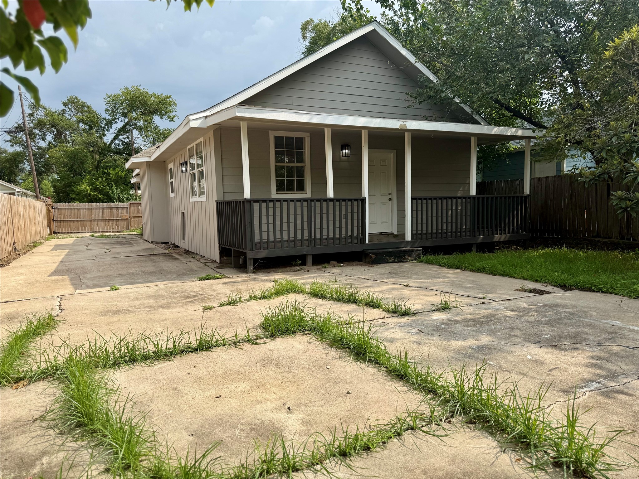 1816 Ryon Street Houston, TX 77009 - Photo 13 of 14 a view of backyard with large trees and wooden fence