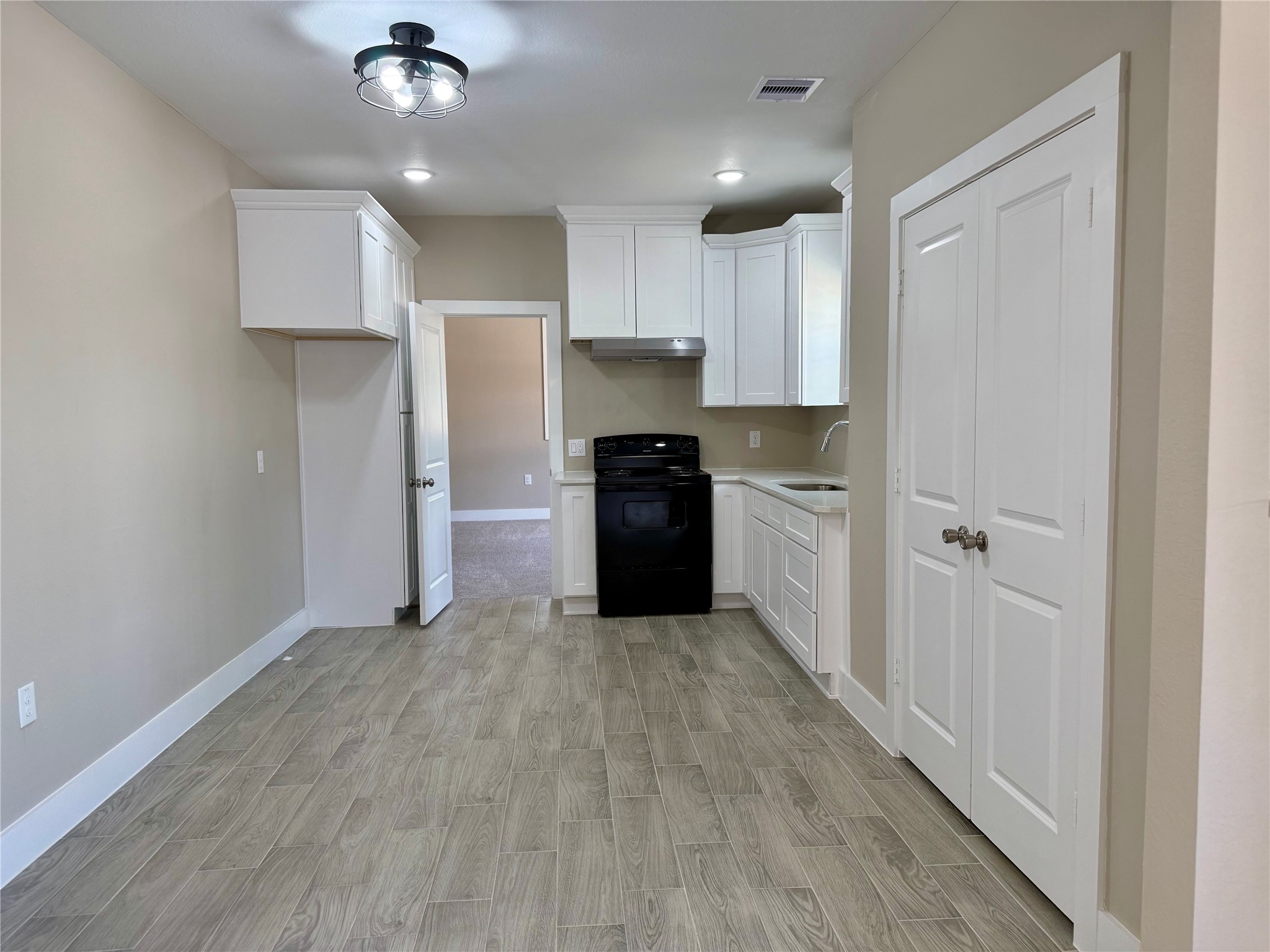 1816 Ryon Street Houston, TX 77009 - Photo 2 of 14 a kitchen with stainless steel appliances granite countertop a refrigerator and a stove top oven