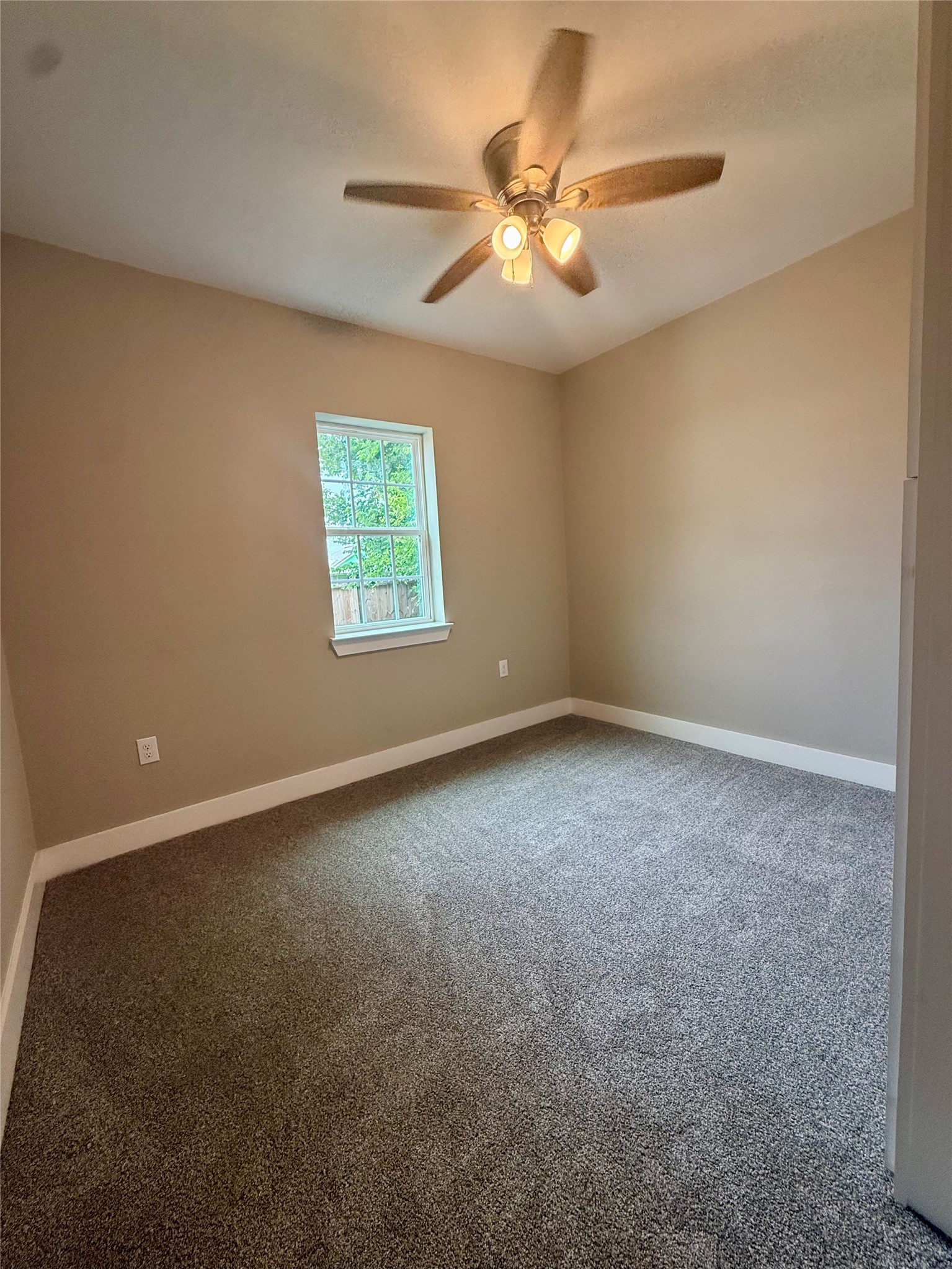 1816 Ryon Street Houston, TX 77009 - Photo 7 of 14 an empty room with windows and fan