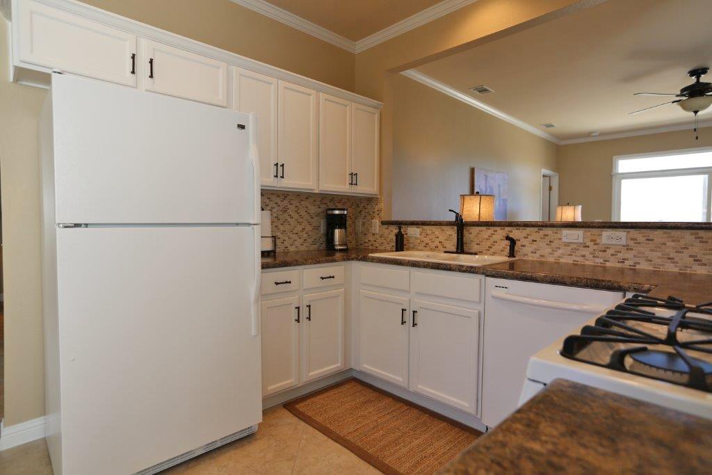 109 Ranier Lane Georgetown, TX 78633 - Photo 3 of 18 White cabinetry and countertops provide a crisp, clean aesthetic in this kitchen.