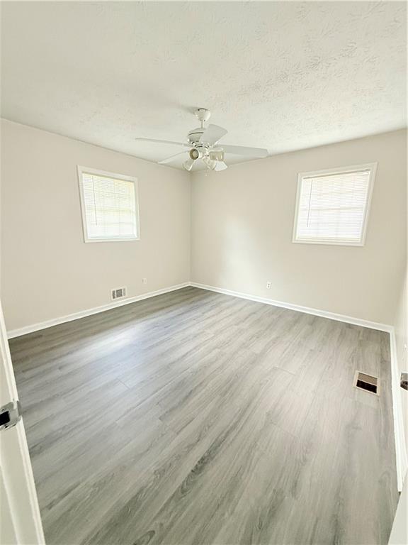 554 Fort Street Northeast Marietta, GA 30060 - Photo 11 of 15 wooden floor in an empty room with a window