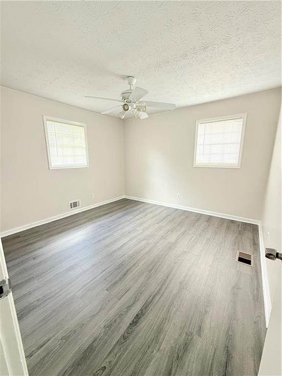 554 Fort Street Northeast Marietta, GA 30060 - Photo 15 of 15 wooden floor in an empty room with a window