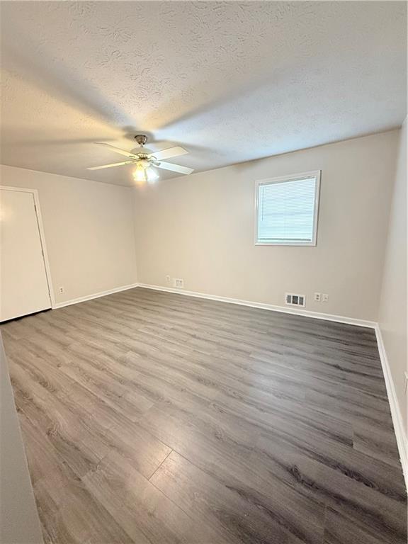 554 Fort Street Northeast Marietta, GA 30060 - Photo 4 of 15 wooden floor in an empty room with a window