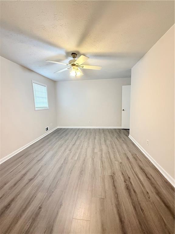 554 Fort Street Northeast Marietta, GA 30060 - Photo 8 of 15 an empty room with wooden floor and windows