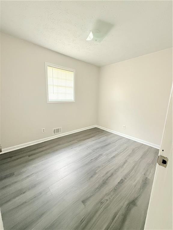 554 Fort Street Northeast Marietta, GA 30060 - Photo 9 of 15 an empty room with wooden floor and windows