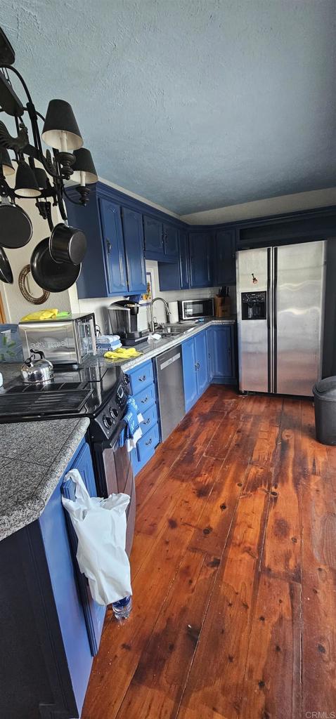 405 Solana Real Fallbrook, CA 92028 - Photo 5 of 11 a kitchen with stainless steel appliances kitchen island granite countertop a stove a sink and a microwave