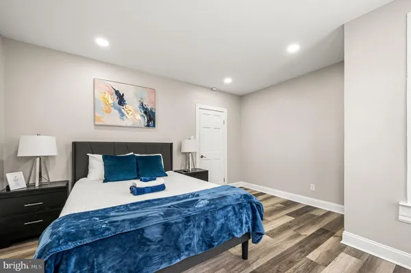 a bedroom with a bed and a painting on the wall
