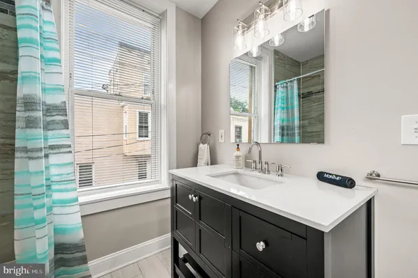 a bathroom with a sink and a window