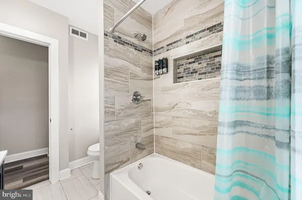 a bathroom with a shower and a toilet