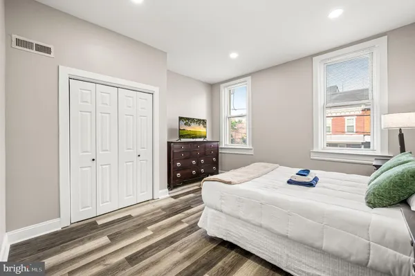 a bedroom with a bed and a window