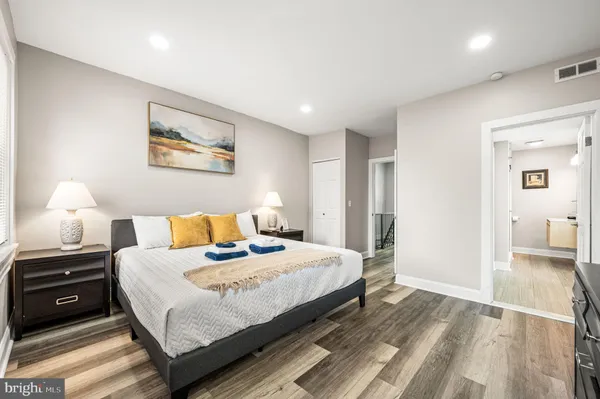 a bedroom with a bed and wooden floor