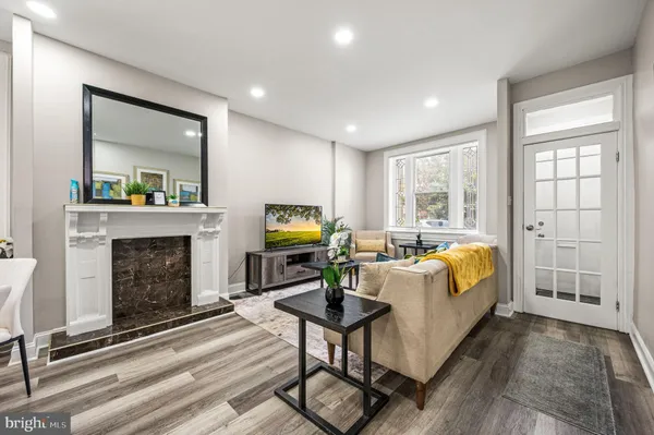 a living room with furniture a fireplace and a table