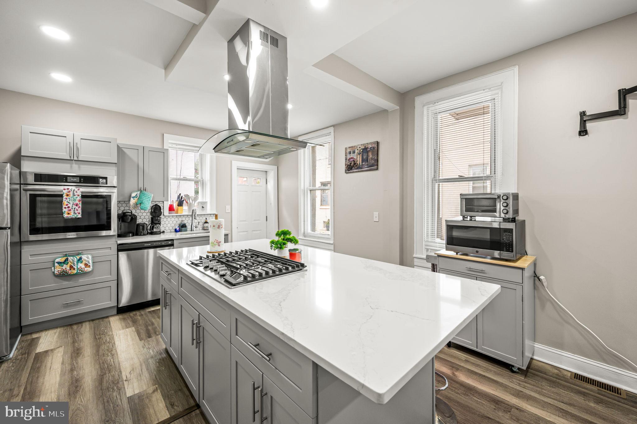 930 North 30th Street Philadelphia, PA 19130 - Photo 6 of 20 a kitchen with granite countertop stainless steel appliances a stove oven and a refrigerator