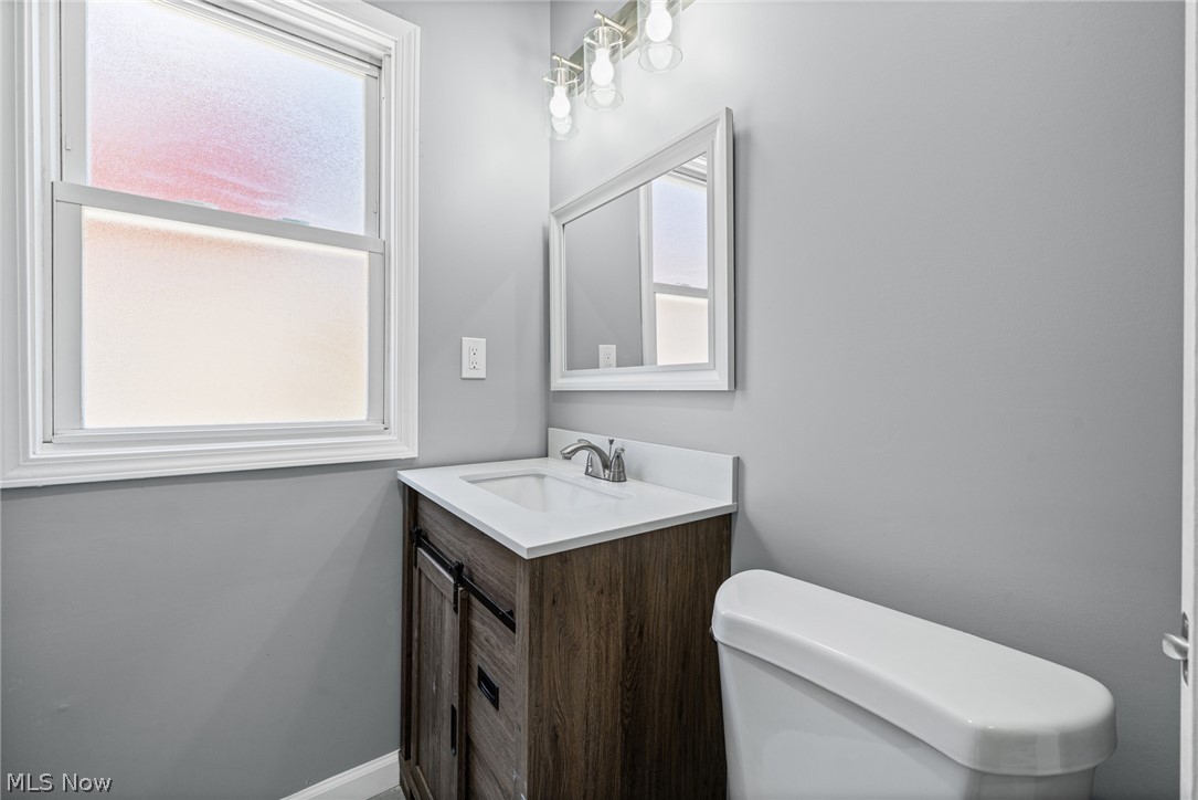 3925 Riverside Avenue Cleveland, OH 44109 - Photo 19 of 48 Bathroom featuring a single vanity with wood-finish cabinetry, white countertop, and an integrated sink