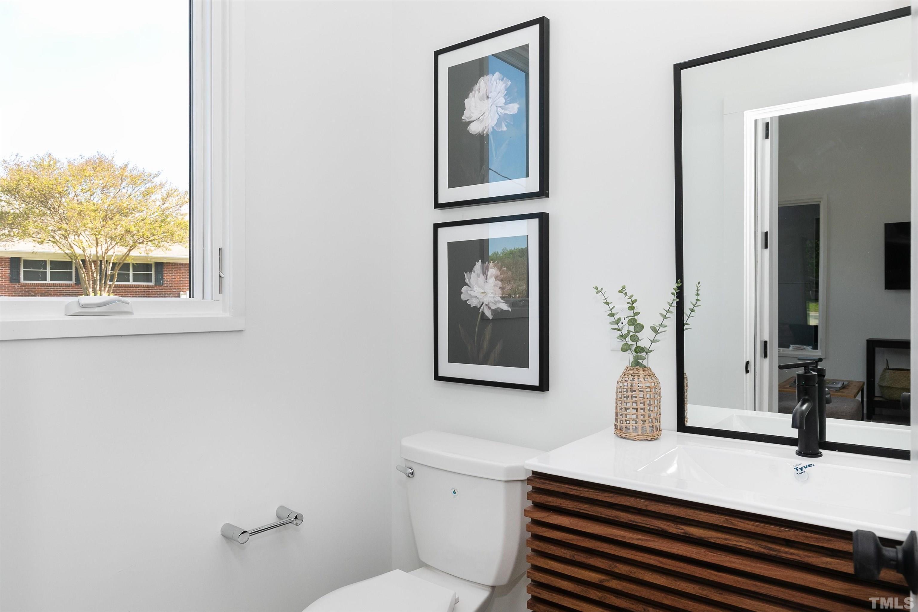 2159 Mayview Road, Unit B Raleigh, NC 27607 - Photo 25 of 29 a bathroom with a sink a toilet and mirror