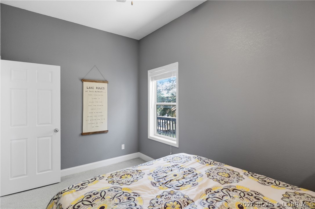 1492 Purvis Road Sunrise Beach, MO 65079 - Photo 33 of 41 Lower-level bedroom with natural light