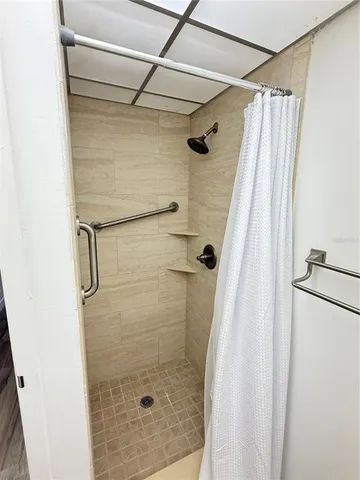 a bathroom with a shower and a glass door