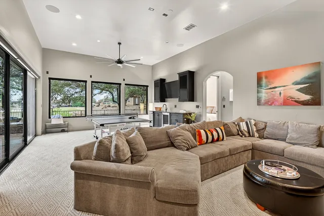 a living room with furniture and a large window
