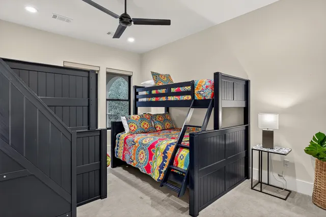 a bedroom with a bed and a ceiling fan