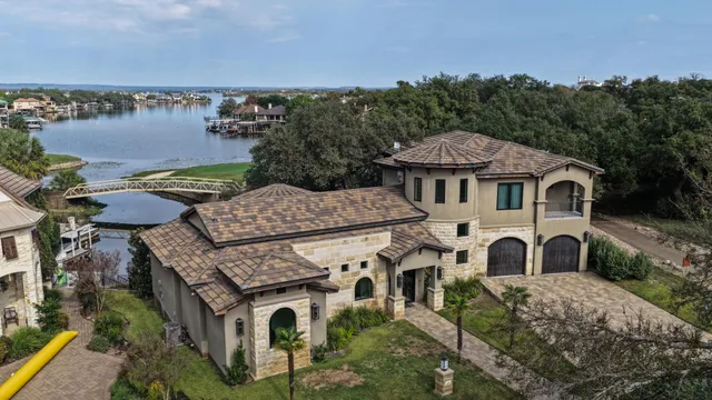 an aerial view of a house with a garden and lake view