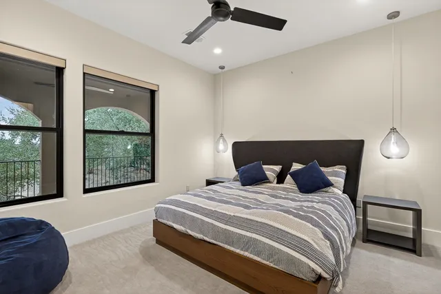 a bedroom with a large bed and a window